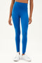 Front view of girl wearing blue leggings and white shoes